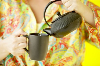 Woman pouring cup of tea
