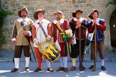 men dressed in period costumes