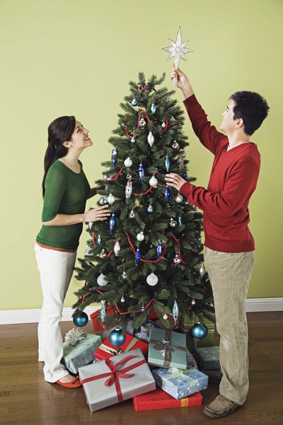 Couple decorating Christmas tree