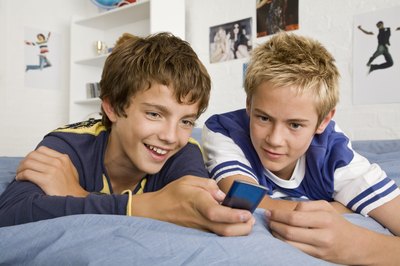 Teenage boys looking at iPod Nano