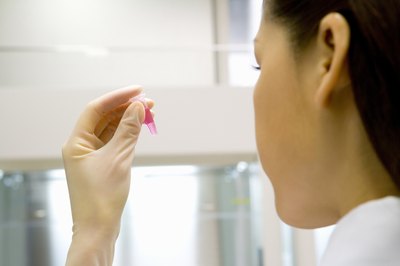 A chemical engineer analyzes a liquid in a small tube.