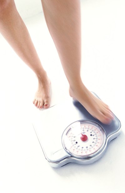 Woman measuring her weight