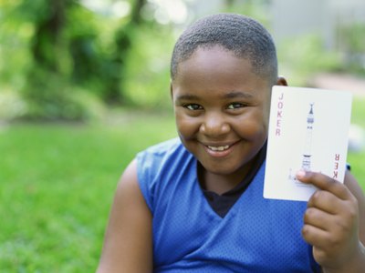 child holding playing card