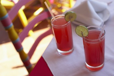 Two cranberry juice glasses on table
