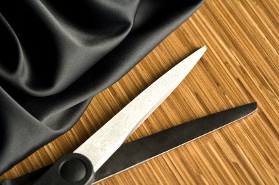 Scissors next to cap fabric