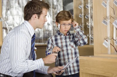 Child trying on glasses.