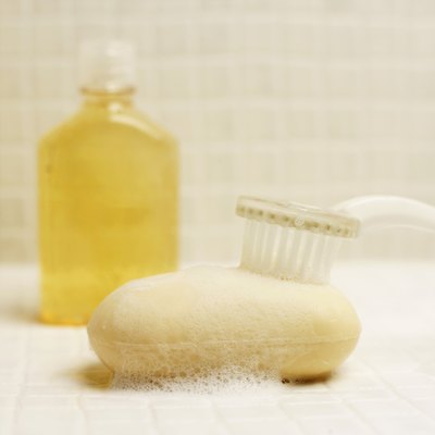 A close-up of a bar of soap and a bottle of shampoo.