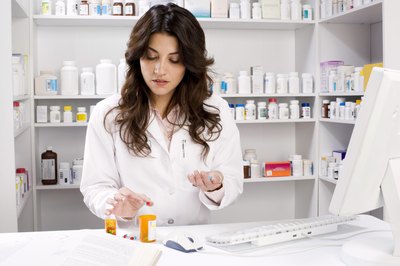 Pharmacist counting pills