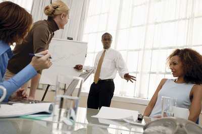 Man pointing at a chart in a business meeting