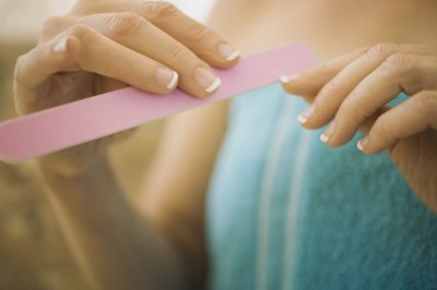 Woman filing her nails