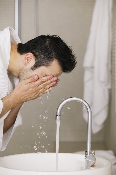 Man splashing face with water
