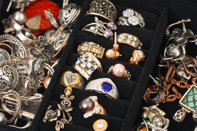 Various rings, pendants and earrings in a jewelry box.
