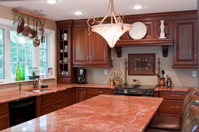 Dark cabinets and red granite counters create an elegant, warm kitchen.