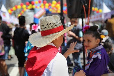 Two children wearing historic costumes during a festival.