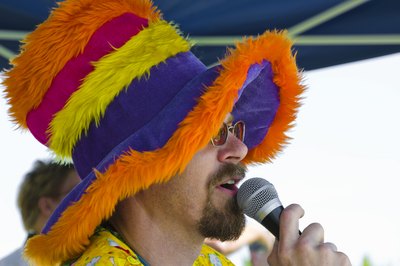 Man with funny hat talks into microphone