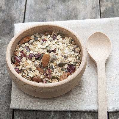 Whole grain cereal in a wooden bowl.