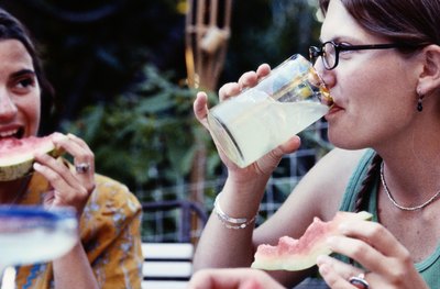 Woman drinking glass of lemonade.