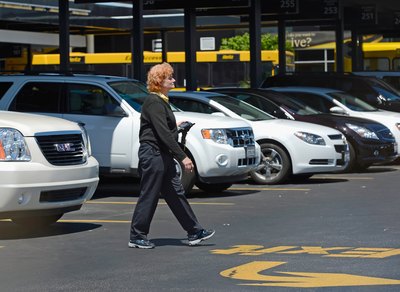 Woman walking in car rental lot
