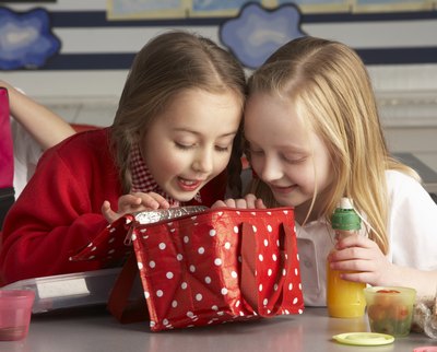 Children looking in insulated lunch box