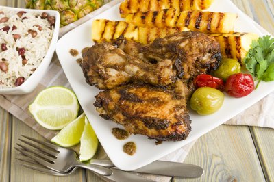 Plate of jerk chicken and grilled pineapple