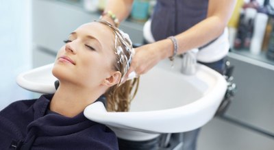 woman having hair washed in salon