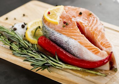 A salmon filet with rosemary and spices.
