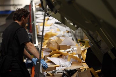 The postal service delivers nearly 210 million pieces of first-class mail daily.