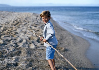 child finding a stick to make a stick horse