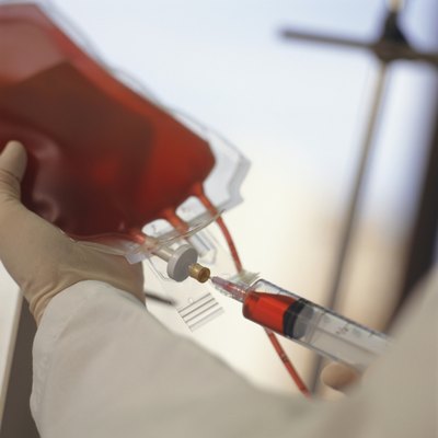 A physician takes a sample of blood.