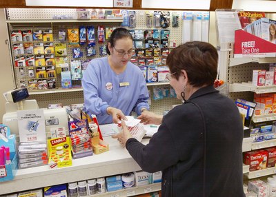 Store clerk helping customer with perscription