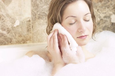 Woman with washcloth on ear