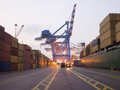 Traffic lanes run through an industrial shipping yard.