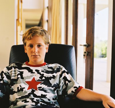 Young boy sitting in chair