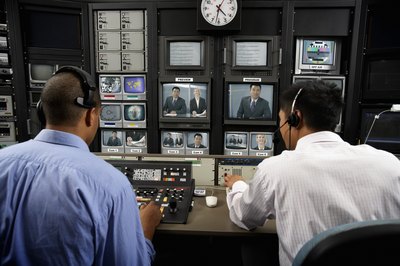 two men film editing in TV studio