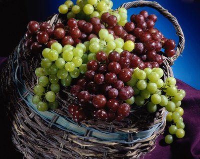 Red and white grapes on a basket