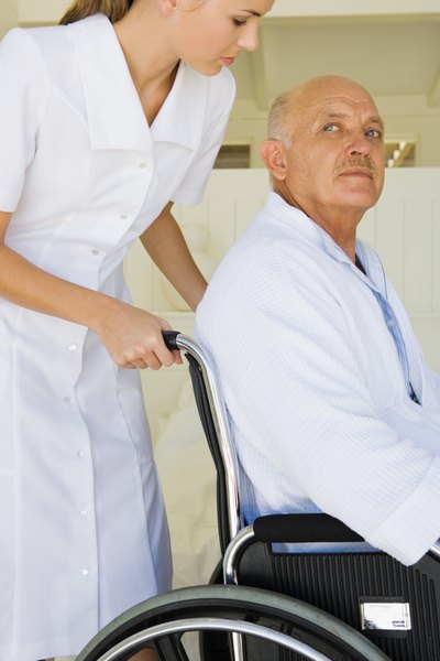 Nurse and elderly man in wheelchair