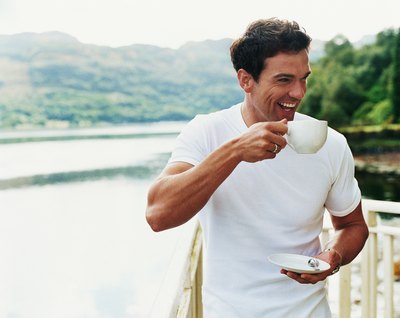Caffeine causes an increase of dopamine in the brain leading to feelings of happiness.