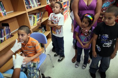 Children receiving The Flu Mist Vaccine at school