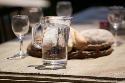 A pitcher of water at an outdoor cafe.