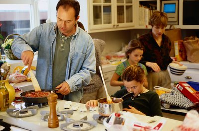 A family cooking together in the kitchen.
