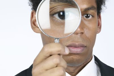 Use a magnifying glass to look for ticks.