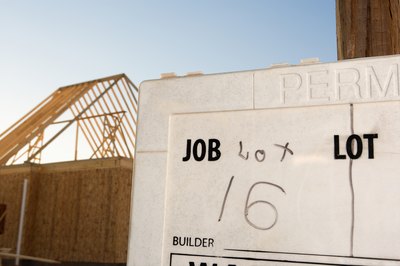 A close-up of a permit to build posted on a job site.