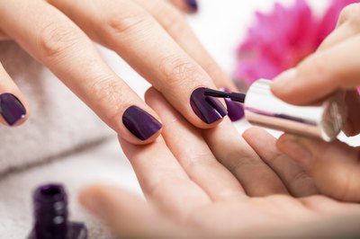 Woman's fingers getting painted