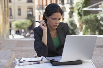 A woman is browsing ads on her laptop.