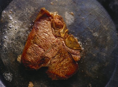 Sear the steak in the pan before transferring the pan to the oven to cook.