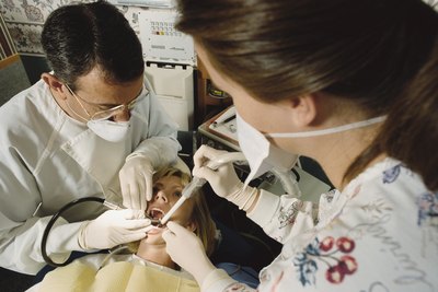Patient during dental procedure with a drill.
