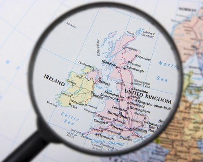 Magnifying glass over map of the UK