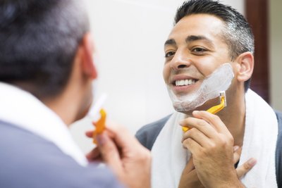 Man shaving with a gilette razor.