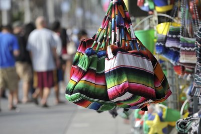 Bags and wares for sale along Venice Beach boardwalk stall, CA.