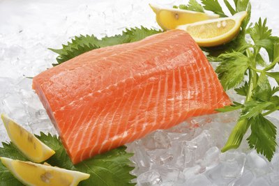 Salmon on ice with lemons and herbs.